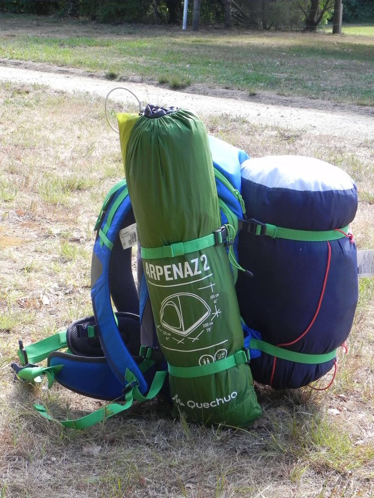 Green tent on a backpack.